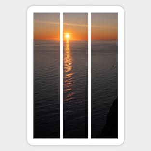 Wonderful landscapes in Norway. Nord-Norge. Beautiful scenery of a midnight sun sunset at Nordkapp (Cape North). Boat and globe on a cliff. Rippled sea and clear orange sky. (vertical) Sticker